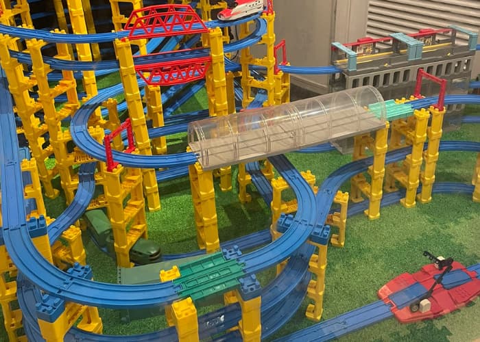 Children playing with Plarail trains in indoor playland