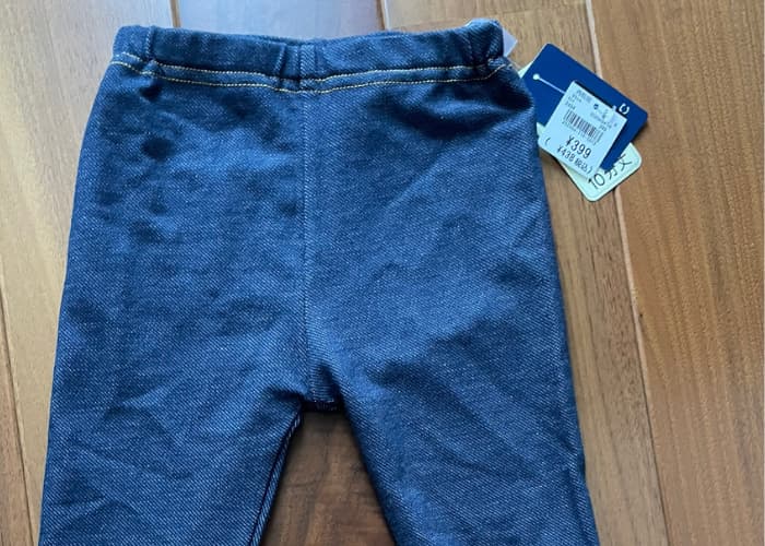 Colorful children's clothes displayed at Nishimatsuya store in Oita, Japan — affordable baby and kids' fashion for traveling families